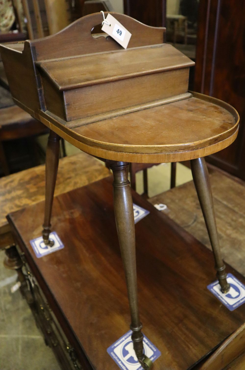 A Victorian mahogany sewing table on slender splayed baluster legs with brass caps and castors, width 54cm depth 33cm height 70cm